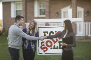real estate agent selling house to couple