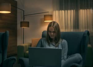 Woman studying for the North Carolina real estate exam at home