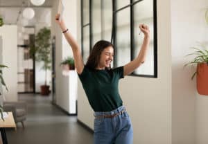 Woman raising arms in triumph