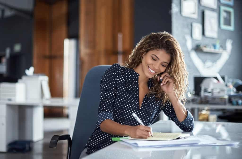 real estate broker talking to prospects on phone in office