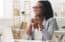 North Carolina mortgage loan officer smiling, sitting at desk in modern office