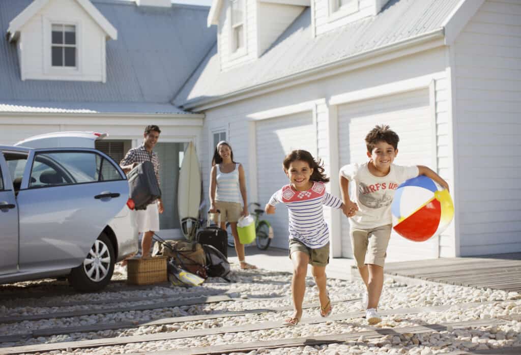 kids running from the car to their new vacation home