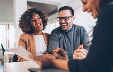 Real estate broker talking and laughing with new clients