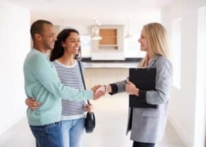 North Carolina real estate broker showing a home to a young couple