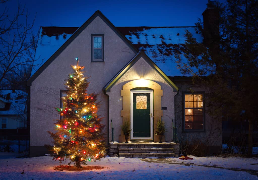 Outdoor Christmas Tree Decorated with Lights in Front of Home