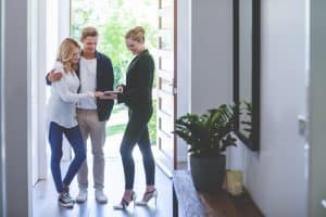 North Carolina real estate broker showing young couple a contemporary luxury home