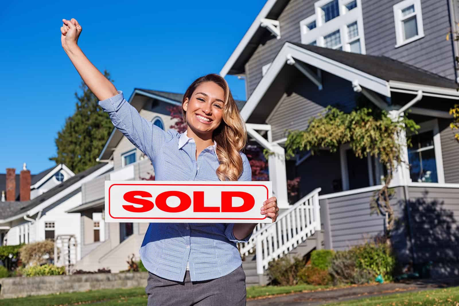 Young Hispanic Realtor with SOLD Sign