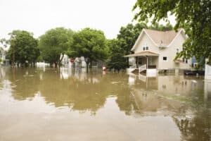 Water floods residential neighborhood, homeowners' flood insurance concept