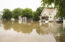 Water floods residential neighborhood, homeowners' flood insurance concept