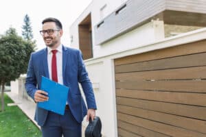 Smiling successful young real estate broker on the job