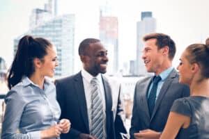 Group of happy brokers talking outdoors with city scape in the background, North Carolina real estate income concept