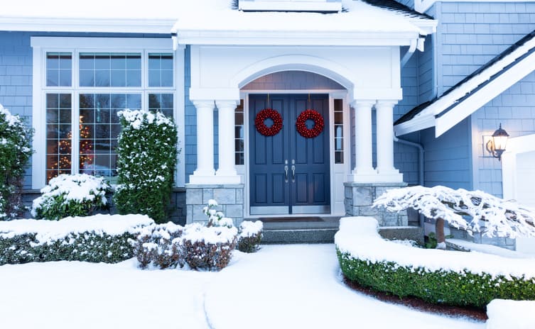 Walkway to a fresh blanket of snow on residential home, holiday open house concept.