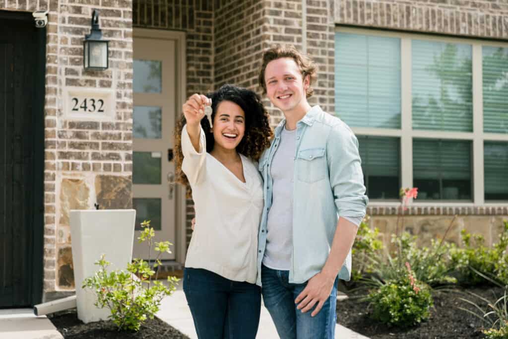 Couple proudly shows off key to new home