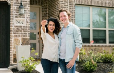 Couple proudly shows off key to new home
