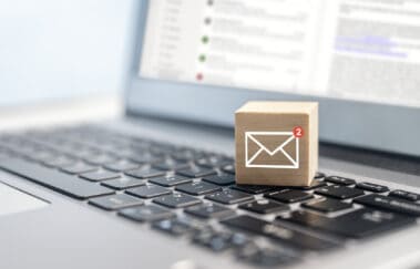 New email symbol on wooden block on laptop keyboard