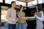 real estate agent shakes hands with couple
