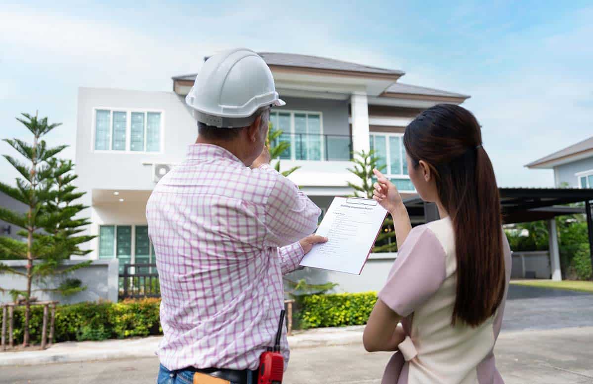 real estate broker and appraiser look at home