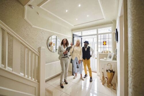 couple looks at home with real estate agent